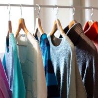 clothes rail with colorful cashmere sweaters - fashion stock-fotos und bilder