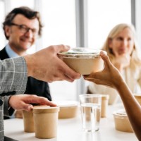 co-workers enjoying a take-away meal at lunch break - junk food stock pictures, royalty-free photos & images