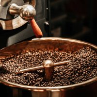 coffee beans being cooled after being roasted from a coffee roaster machine - coffee stock pictures, royalty-free photos & images