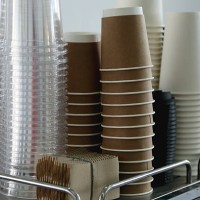 coffee corner with stack of brown paper disposable coffee cup and plastic glasses for mocktails - junk food stock pictures, royalty-free photos & images