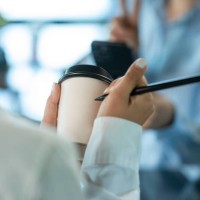 coffee shop, baristas taking order and writing customer name on paper cup for ordering. - junk food stock pictures, royalty-free photos & images