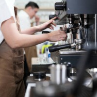 coffee shop franchise solution. side view of asian female barista making brewed coffee for serving to customer order. - junk food stock pictures, royalty-free photos & images