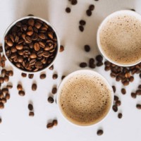 coffee to go in tray on white table with coffee beans and straws - junk food stock pictures, royalty-free photos & images