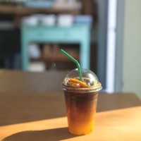 cold drink in disposable cup, espresso coffee with orange juice drink. - junk food stock pictures, royalty-free photos & images