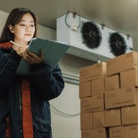 cold storage worker woman using digital tablet to check stock. - food stock pictures, royalty-free photos & images