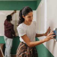 collaborative task: man and woman working together - home decoration stock pictures, royalty-free photos & images