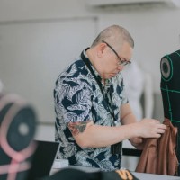 college fashion design lecturer showing his students on the fashion design clothing pin on mannequin - fashion stock pictures, royalty-free photos & images