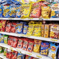 Colombia, Cartagena, La Matuna, Exito Mercado, Chips and junk food aisle.