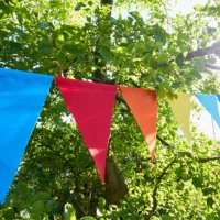 colorful bunting flags/ pennant chant at an apple tree for party decoration in garden - garden decoration stock pictures, royalty-free photos & images