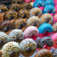 colorful donuts on display - junk food stock pictures, royalty-free photos & images