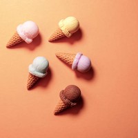 colorful ice cream cones lying on orange background - junk food stock pictures, royalty-free photos & images