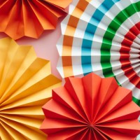 colorful paper fans, party and home wall and window decorations, festive paper trendy background for holidays and celebrations. - home decoration stock pictures, royalty-free photos & images