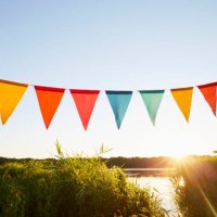 colorful pennant flags for party decoration at lake against sky - garden decoration stock pictures, royalty-free photos & images