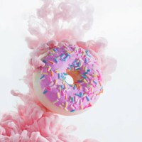 colorful pink cloud around a sweet donut with sprinkles. dissolving paint on a white background with copy space - junk food stock pictures, royalty-free photos & images