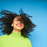 colourful studio portrait of a young woman dancing - hairstyle stockfoto's en -beelden
