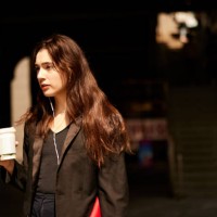 commute harmony: businesswoman in suit listens to music with coffee in hand. - junk food stock pictures, royalty-free photos & images