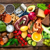 composition of healthy food aranged in a row on wooden table - food stock pictures, royalty-free photos & images