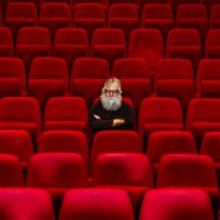 concept loneliness :one man sits in empty cinema or theatre. - concert stock pictures, royalty-free photos & images