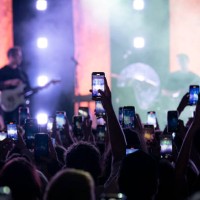Concert-goers record and take photos with their smartphones during the Joshua Bassett concert at the Bataclan on May 4, 2023 in Paris, France.