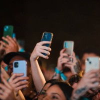 Concert-goers use their smartphones during Daniel Caesar concert during the C6 Fest at Parque Ibirapuera on May 19, 2024 in Sao Paulo, Brazil.