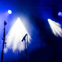 concert microphones stands on a blue stage under spotlights - concert stock pictures, royalty-free photos & images