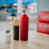 condiment bottles on a table in a diner - junk food stock pictures, royalty-free photos & images