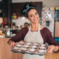 confectioner woman holding a tray of cupcakes - junk food stock pictures, royalty-free photos & images