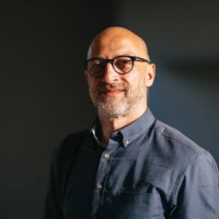 confident businessman smiling in sunlit urban environment - fashion stock pictures, royalty-free photos & images