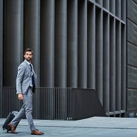 confident businessman with bag against building - travel stock pictures, royalty-free photos & images