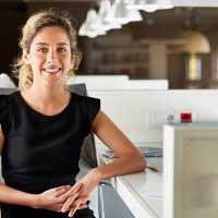 confident businesswoman sitting at desk - fashion stock pictures, royalty-free photos & images