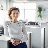 confident businesswoman with hands clasped - fashion stock pictures, royalty-free photos & images