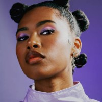 confident female with bold personality and cool attitude. portrait of an edgy young woman wearing fashionable purple makeup and clothes with a trendy hairstyle against a vibrant studio background. - fashion stock pictures, ro