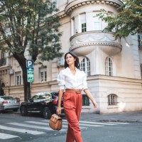 confident woman strolling through scenic urban neighborhood street - fashion stock pictures, royalty-free photos & images