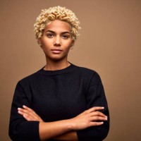 confident young female afro owner against brown background - fashion stock pictures, royalty-free photos & images