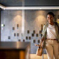 confident young woman arriving in hotel reception - travel stock pictures, royalty-free photos & images