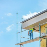 construction worker applying plaster on building facade - home decoration stock pictures, royalty-free photos & images