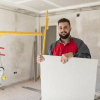 construction worker installs plasterboard ceilings and insulation. drywall ceiling - home decoration stock pictures, royalty-free photos & images