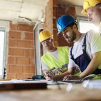 construction workers analyzing blueprints while working at construction site. - home decoration stock pictures, royalty-free photos & images