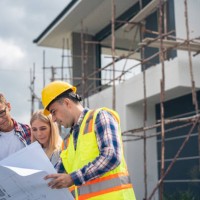 construction: young couple look at home plans with builder. - home decoration stock pictures, royalty-free photos & images