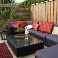 contemporary patio with large wicker sofa. garden design - home decoration stockfoto's en -beelden