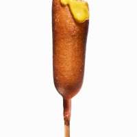 corn dog with mustard and bite out - junk food stock pictures, royalty-free photos & images
