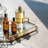 cosmetic products and mirror on table. unrecognizable bottles of perfume and samplers. beauty concept - home decoration stock pictures, royalty-free photos & images