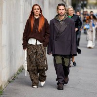 Couple Alice Barbier wears hoody, camouflage pants & Sebastian Roques wears oversized blazer outside Givenchy during the Womenswear Spring/Summer...