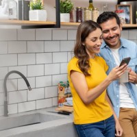 couple at home looking at social media on their cell phone - food stock pictures, royalty-free photos & images