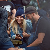 couple checking phone at festival - concert stock pictures, royalty-free photos & images