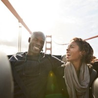 couple cheering and laughing on the backseat of convertible car - travel stock-fotos und bilder