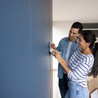 couple choosing a color to paint the walls of their house - home decoration stock pictures, royalty-free photos & images