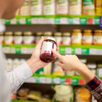 couple choosing jar of jam - food stock pictures, royalty-free photos & images
