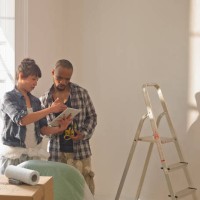 couple doing diy looking at a tablet computer - home decoration stock pictures, royalty-free photos & images
