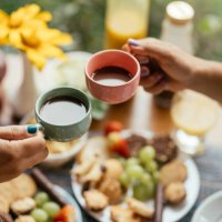 couple drinking coffee together over breakfast on the patio of a bnb - coffee stock pictures, royalty-free photos & images